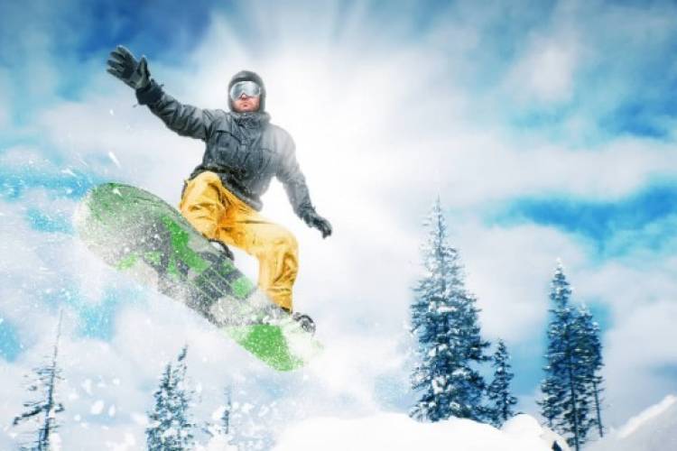 Man snowboarding on Ober Mountain.