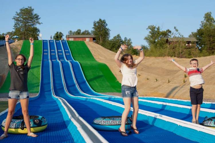 Kids sliding down a slide.